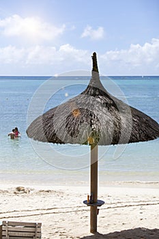 Straw sunshade on the beach
