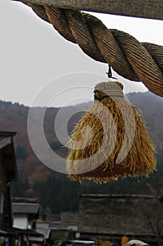 Straw tassel hung from Shimenawa rice straw rope denoting sanctity in Shirakawago Village photo