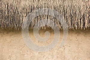 straw thatched roof and soil wall background