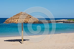 Straw Umbrella On Empty Tropical Beach Background
