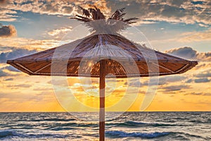 Straw umbrella on tropical sea beach