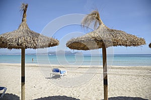 Straw Umbrellas on a Sandy Beach