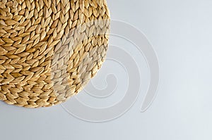 Straw woven circle on a gray background.