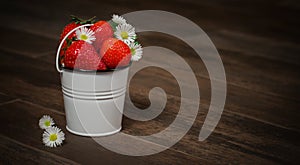 Strawberries and asters in a bucket