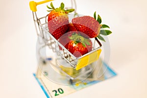 Strawberries in a basket on banknotes