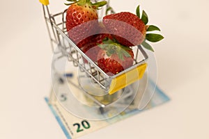 Strawberries in a basket on banknotes