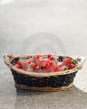 Strawberries basket on concrete background