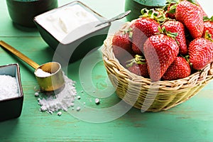 Strawberries in the basket on the wooden table