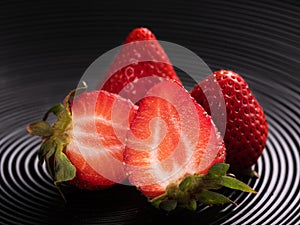 Strawberries on a black plate