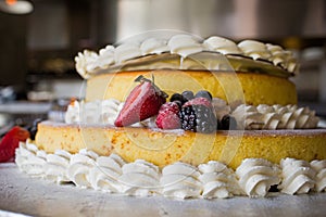 Strawberries and blueberries on top of a delicious cake