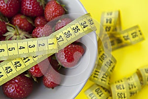 Strawberries bowl with tape measure