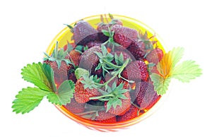 Strawberries in a bowl on a white background