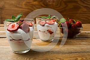 Strawberries cream cheese dessert on wooden background