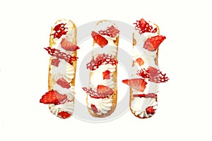 Strawberries and cream eclairs with fresh berries and red lace tuile top down on white background