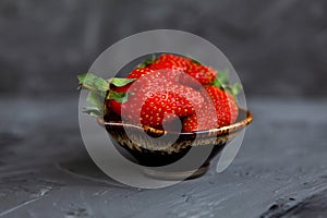 Strawberries in a Cup on a grey concrete background