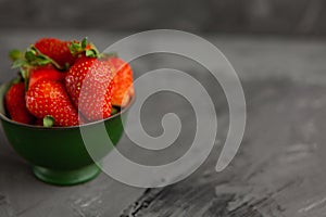 Strawberries in a Cup on a grey concrete background