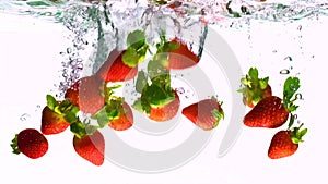 strawberries falling in water