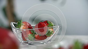 Strawberries fill up the glass cup