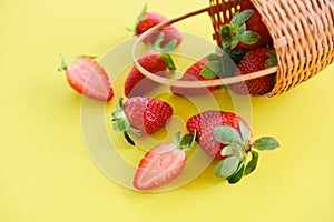 Strawberries fresh on yellow background - ripe red strawberry picking in basket