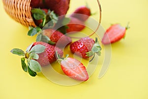 Strawberries fresh on yellow background - ripe red strawberry picking in basket