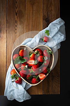 Strawberries fruits in a woodendish. Rustic fruit background