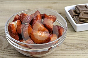 Strawberries in glass bowl with chocolate.