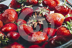 strawberries in a glass jar on the table. white background. Summer fruits. Seasonal fruits and vegetables. Vegetarian food.