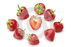 Strawberries isolated on white background, red berries whole and sliced in details, concept of fresh fruits and healthy food