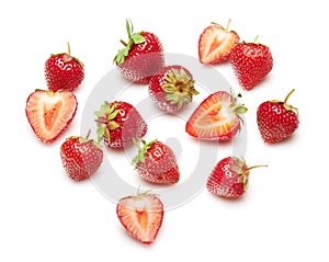 Strawberries isolated on white background, red berries whole and sliced in details, concept of fresh fruits and healthy food