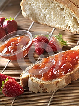 Strawberries with jam and slice of bread.