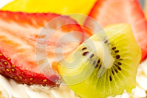 Strawberries kiwi and slice of peach photo