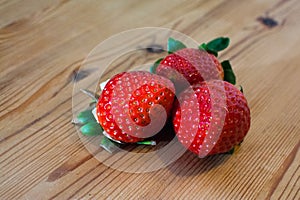 3 Strawberries lying on a table photo