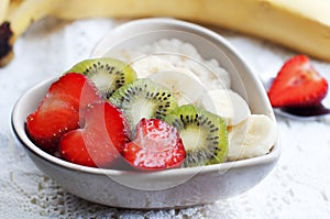 Strawberries with oatmeal, babanas and kiwi in plate