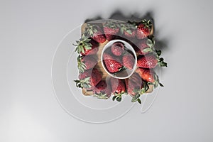 Strawberries over natural wooden background. Top view, copy space