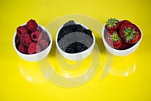 Strawberries, rasberries and blackberries in a bowl
