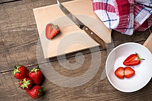 Strawberries sliced on chopping board