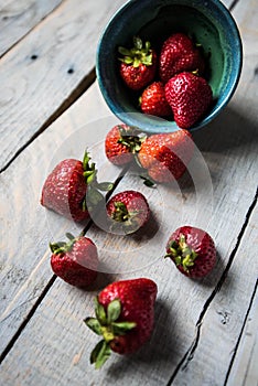 Strawberries spilling out of a bowl