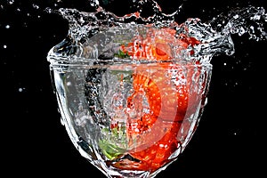 Strawberries splashed in water photo