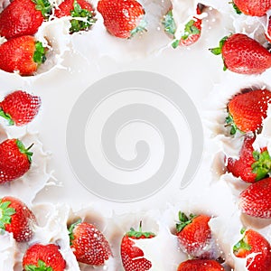 Strawberries splashing into milk frame