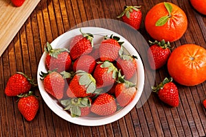 Strawberries and tangerines photo