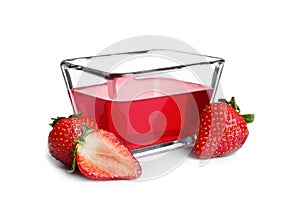 Strawberries and tasty jelly dessert in glass bowl on white