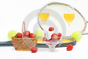 Strawberries with whipped cream, glasses with champagne and  tennis equipment on Wimbledon tournament