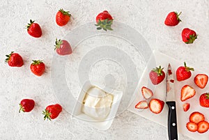 Strawberries on White Marble Cutting Board and a Bowl with Whipped Cream