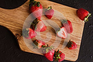 Strawberries on wood in a black background photo