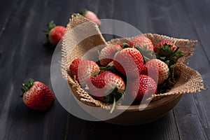 Strawberries in wood bowl. Fresh nice strawberries on wooden table. Juice strawberry
