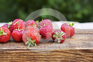 Strawberries on a wooden board, summer harvest