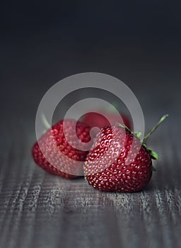 strawberries on wooden dark background, rustic style, close up