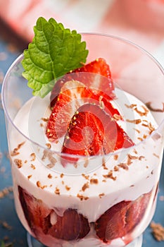 Strawberries with yogurt in a glass close-up. Easy diet dessert. Selective focus