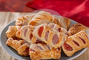 Strawberry and apple filled sugar coated puff pastry cakes close