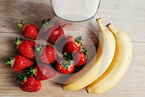 Strawberry banana smoothie fresh blended on wood table